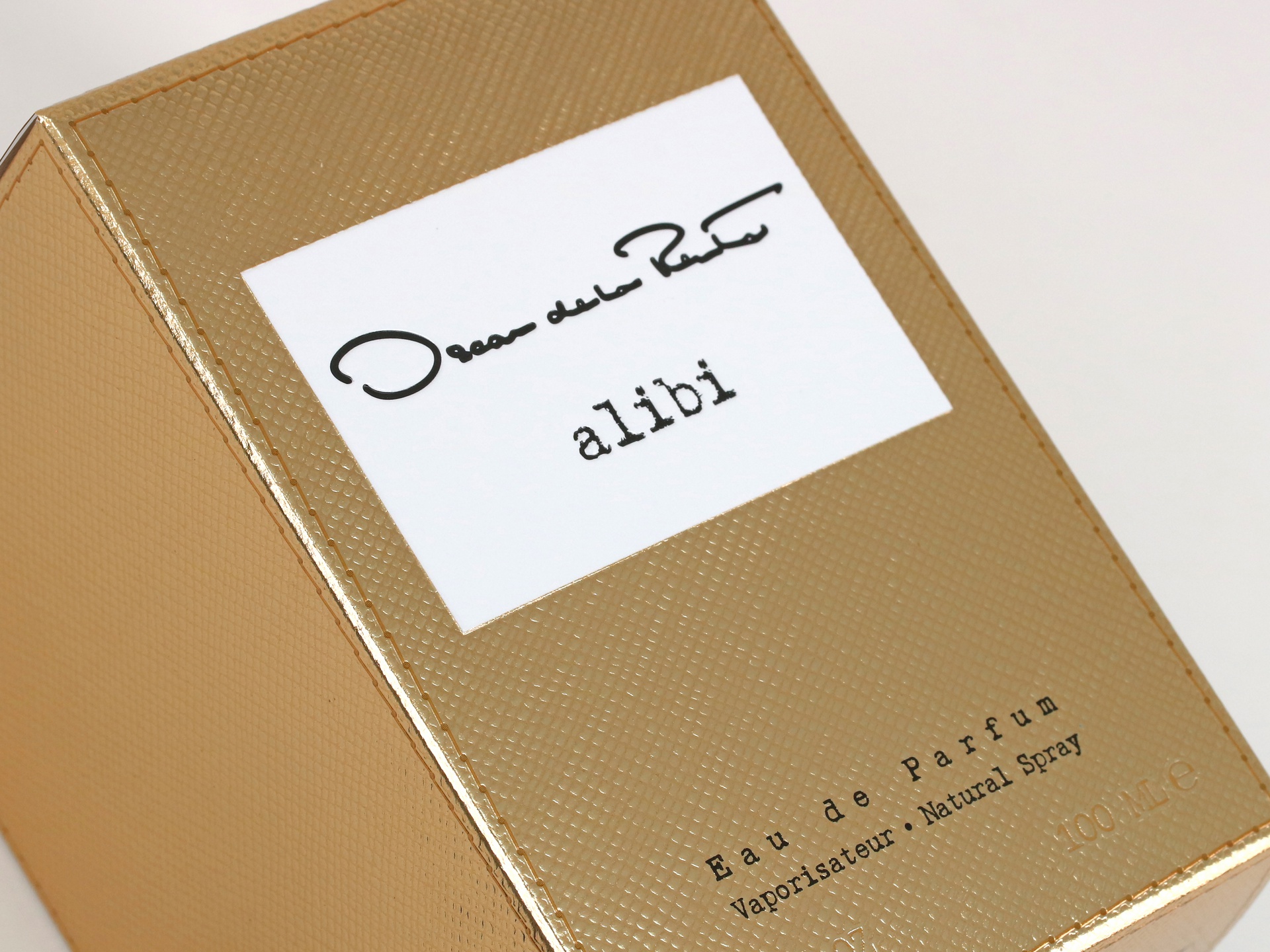 Oscar de la Renta Alibi folding cartons feature cold foil and an overall embossed leather and stitching pattern.