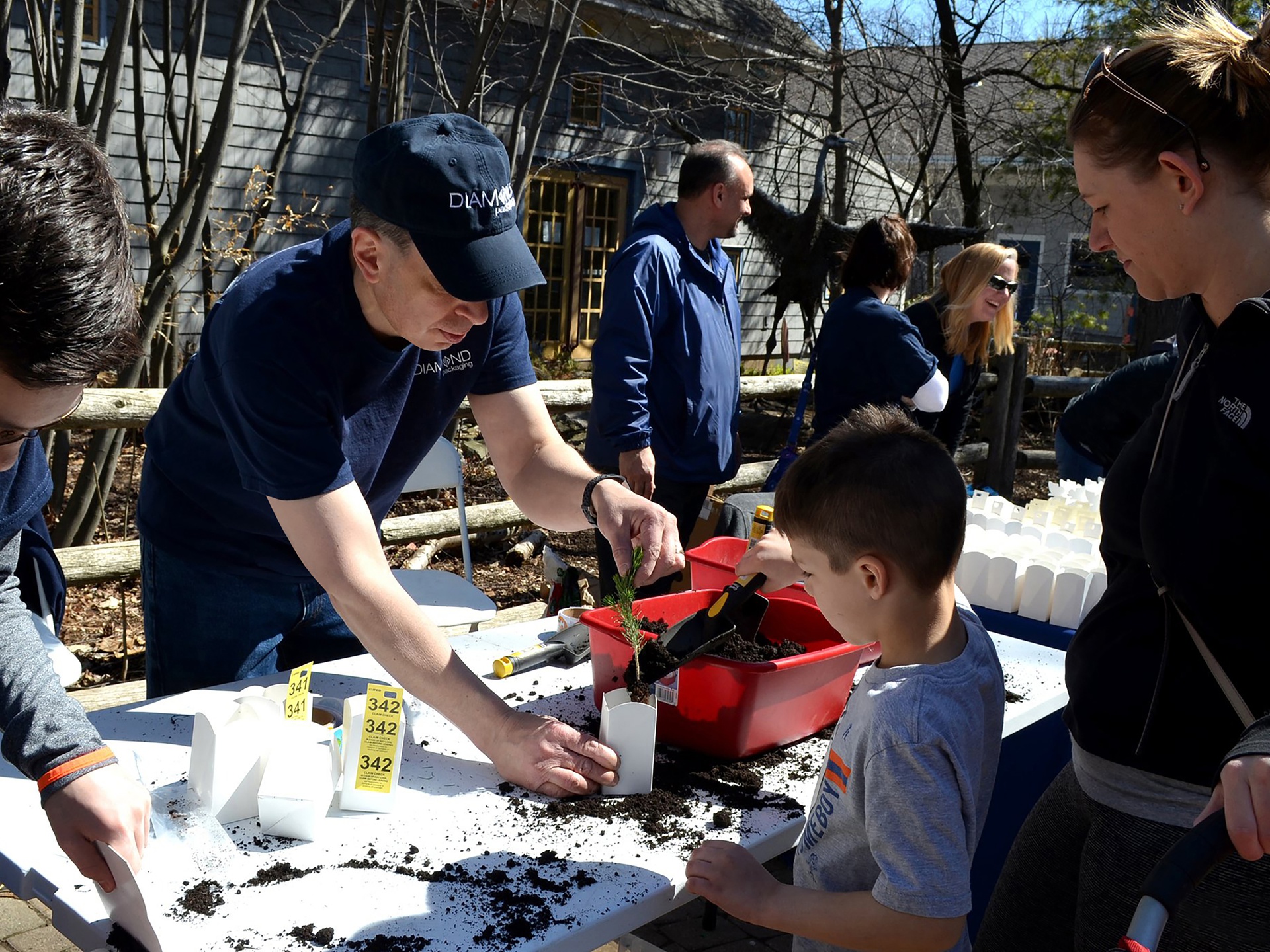 Diamond employees helped kids plant trees as part of the TICCIT (“Trees into Cartons, Cartons into Trees”) program.